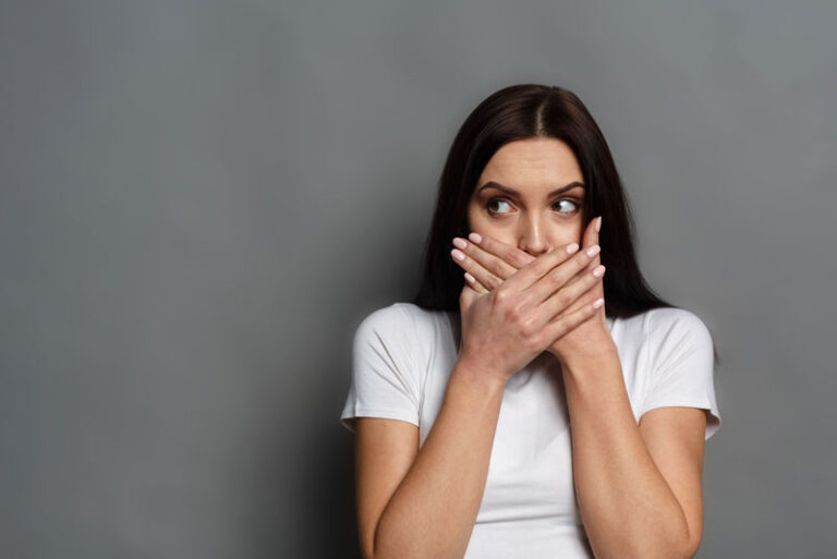 Dental Patient Shyly Hiding Her Missing Tooth In Her Smile