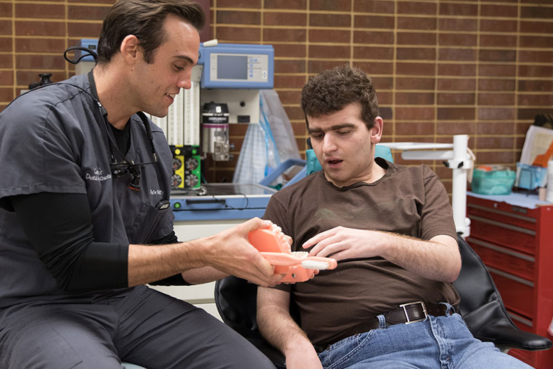 special needs male patient with kyle duffy during dental proc